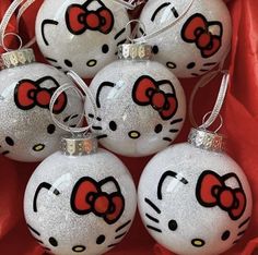 hello kitty christmas ornaments with red bows on them