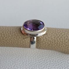 Gemstone-Amethyst Shape-Oval Stone Size- 12x16 MM Metal-925 Sterling Silver This One of a kind ring is adorned with beautiful Purple Amethyst Gemstone in sterling silver.Amethyst is the birthstone representing the month of February. About gemstone-.Amethyst is linked to the element of wind.It is believed to prevent intoxication.This purple gemstone is associated with Royalty.This stone has amazing healing power and very helpful in purifying the mind and relieving stress.Amethyst is the stone of Gift Bezel Set Oval Cabochon Amethyst Ring, Classic Oval Amethyst Crystal Ring, Oval Cabochon Amethyst Ring With Bezel Setting As Gift, Amethyst Rings With Large Oval Stone, Oval Purple Ring With Bezel Setting, Adjustable Oval Sapphire Ring, Oval Amethyst Ring With Large Stone, Oval Amethyst Rings With Polished Finish, Adjustable Silver Amethyst Ring, Oval Shape