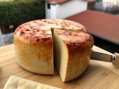 a cheesecake on a cutting board with a knife