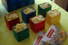 there are many small blocks with popcorn in them on the table next to each other