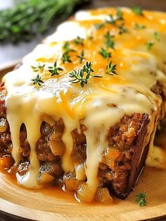 meatloaf covered in gravy on a wooden plate