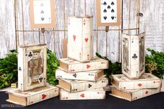 several playing cards are stacked on top of each other in front of a wooden fence