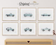 four framed photographs of cars are hanging on the wall above a wooden dresser and sideboard