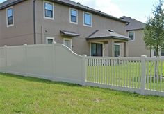 a white fence in front of a house