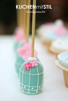 an image of some cupcakes that are on the table with sticks in them