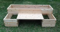 a wooden bench sitting on top of a lush green field