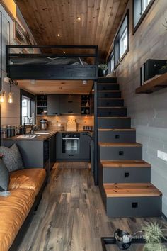 a living room with stairs leading up to the kitchen