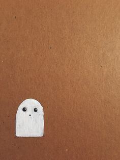 a piece of paper that has been cut into the shape of a ghost with eyes