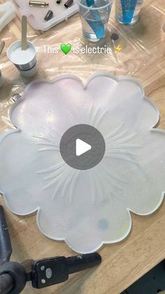 a video demonstrating how to make an acrylic flower decoration with glue and water