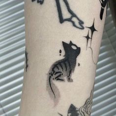 a person with a cat tattoo on their arm