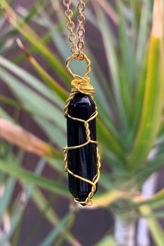 "Beautiful gold wire wrapped Black Agate crystal point pendant on matching chain with lobster claw closure. Other metal colors are available. The pendant is approximately 1.25\" long and 0.4\" wide. Please note that all crystals are unique and therefore color, shape and size may vary slightly. Please choose a necklace length from the drop-down menu. In case you would like a length other than the listed options, leave us a note at checkout. Item will be shipped 2 - 3 business days after purchase. Hand Wrapped Gold Agate Necklaces, Hand Wrapped Gold Agate Necklace, Unique Gold Wire-wrapped Crystal Necklace, Black Wire Wrapped Spiritual Crystal Necklace, Spiritual Agate Necklace With Wire Wrapped, Luxury Wire Wrapped Agate Necklace, Wire Wrapped Amulet Pendant Crystal Necklace, Black Agate Spiritual Necklace, Wire Wrapped Amulet Crystal Pendant Necklace