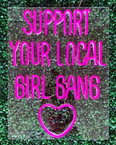 a pink sign that says support your local girl gang on the side of a wall