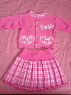 a pink sweater and skirt with the words barbie on it