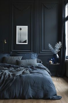 a bedroom with black walls and wooden floors