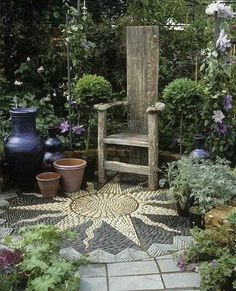 an outdoor garden with potted plants and a wooden chair in the center, surrounded by greenery