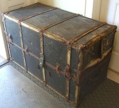 an old trunk is sitting on the floor