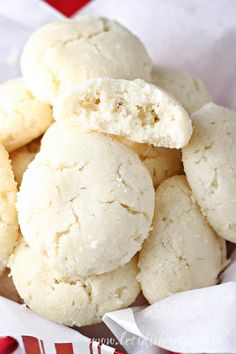 a basket filled with white cookies sitting on top of a red and white table cloth