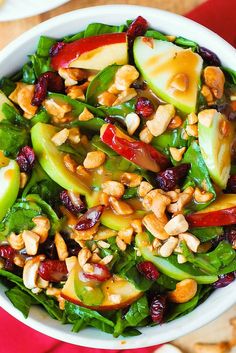 a white bowl filled with fruit and nuts