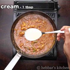 a person stirring food in a pan on top of a stove with the words cream 1 tsp above it