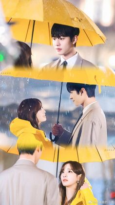 two people standing under yellow umbrellas in the rain, one person holding an umbrella