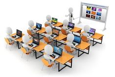 an image of a classroom setting with many computers on the desks and people standing in front of them