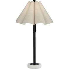 a lamp that is sitting on top of a stand with a white shade over it