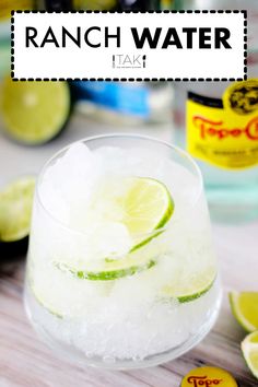 a glass filled with ice and lime slices