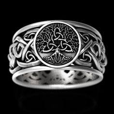 A stunning and bold Tree of Life adorns this sterling silver ring, woven from three Celtic Trinity Knots joined at its heart. Additional trinity knots bind and weave around the sterling silver band, symbolizing the continuous and intertwining nature of true love. The tree of life is sacred to many cultures and is a symbol of personal growth, strength and beauty. It represents our personal development, uniqueness and individual beauty. Just as the branches of a tree strengthen and grow upwards to Mens Celtic Wedding Bands, Viking Aesthetic, Irish Wedding Rings, Celtic Band, Celtic Wedding Bands, Tree Of Life Ring, Pagan Wedding, Ring Tree, Celtic Viking