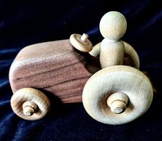 a wooden toy car with two people in it