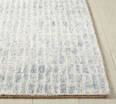 a white and blue rug on the floor