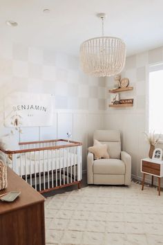 a baby's room with a crib, chair and dresser