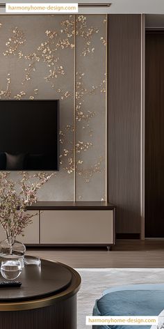 a living room with a large tv mounted on the wall next to a vase filled with flowers