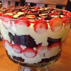 a layered dessert with strawberries and blueberries in it