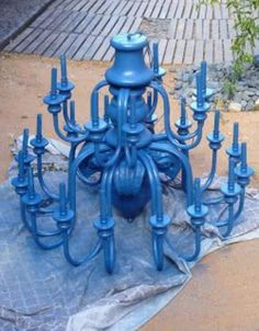 a bunch of blue candles sitting on top of a piece of cloth