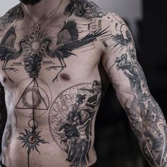 a shirtless man with tattoos on his chest