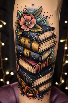 a tattoo with books and flowers on it