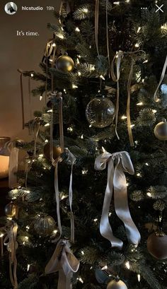 a decorated christmas tree with ornaments and lights in the shape of baubles, bows and ribbons