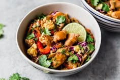 two bowls filled with food and garnished with cilantro