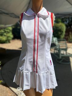 Here is a vintage 1970s Fashion T brand polyester tennis dress .No size.Following are the measurements.Bust 34",Waist 30",Hips 38",Length measured from top of shoulder to hem 29"long.Zips up the front.Made out of white polyester fabric.Zig zag red trim.Nice vintage condition.Please take special consideration of measurements. 1970s sizing was much smaller than today's standards.Tennis dresses were very short not like a regular dress. So please take special note of length.If you live overseas plea Fitted White Tennis Dress With Short Sleeves, Fitted Cotton Tennis Dress For Spring, Fitted Cotton Tennis Dress, White Cotton Tennis Dress, 70s Mode, Tennis Dresses, 60s And 70s Fashion, Seventies Fashion, 2024 Style