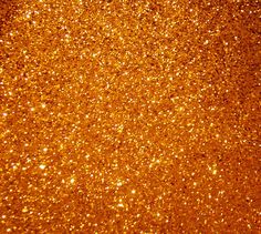 an orange glitter background with lots of gold flecks