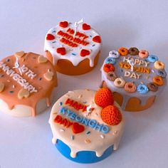 four decorated cupcakes with happy birthday written on them