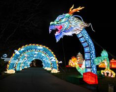 an elaborately decorated dragon and arch at night