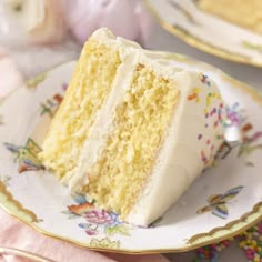 a slice of yellow cake on a plate with flowers and pink napkins next to it