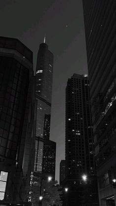 black and white photograph of city buildings at night