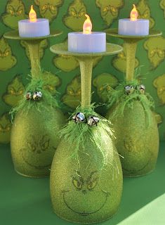 three small green vases with candles in them