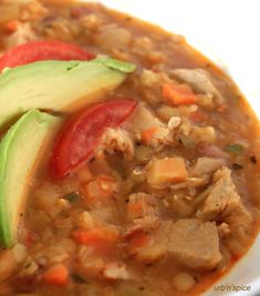 a close up of a bowl of food with meat and veggies on it