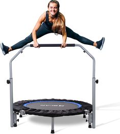 a woman is jumping on a trampoline with her legs spread out in the air