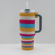 a crocheted coffee cup holder with handle