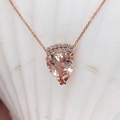 This beautiful pendant necklace features a 2.78 carat pear shape Morganite gemstone with natural earth mined diamonds set in solid 14K gold. This necklace can be a lovely June birthstone gift for your loved ones! This necklace is made with solid 14k gold and natural earth-mined SI G/H diamonds. As listed, this necklace is ready to ship. If you're interested in purchasing this setting with a different center stone please message us! Pear-shaped Morganite Jewelry, Pear-shaped Morganite Gemstone Jewelry, Pear Shaped Rose Gold Fine Jewelry Necklace, Pear-shaped Rose Gold Fine Jewelry Necklace, Pear Shaped Rose Gold Fine Necklace, Rose Gold Pear-shaped Gemstone Necklaces, Morganite Teardrop Jewelry Gift, Rose Gold Pear-shaped Gemstone Necklace, Teardrop Morganite Jewelry Gift