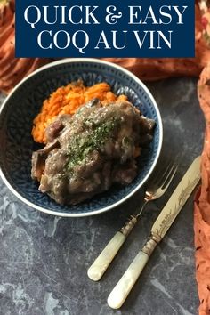 a blue bowl filled with food next to a fork and knife on top of a table